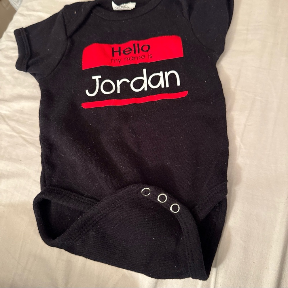 Black Baby Onesie with Red and White Text